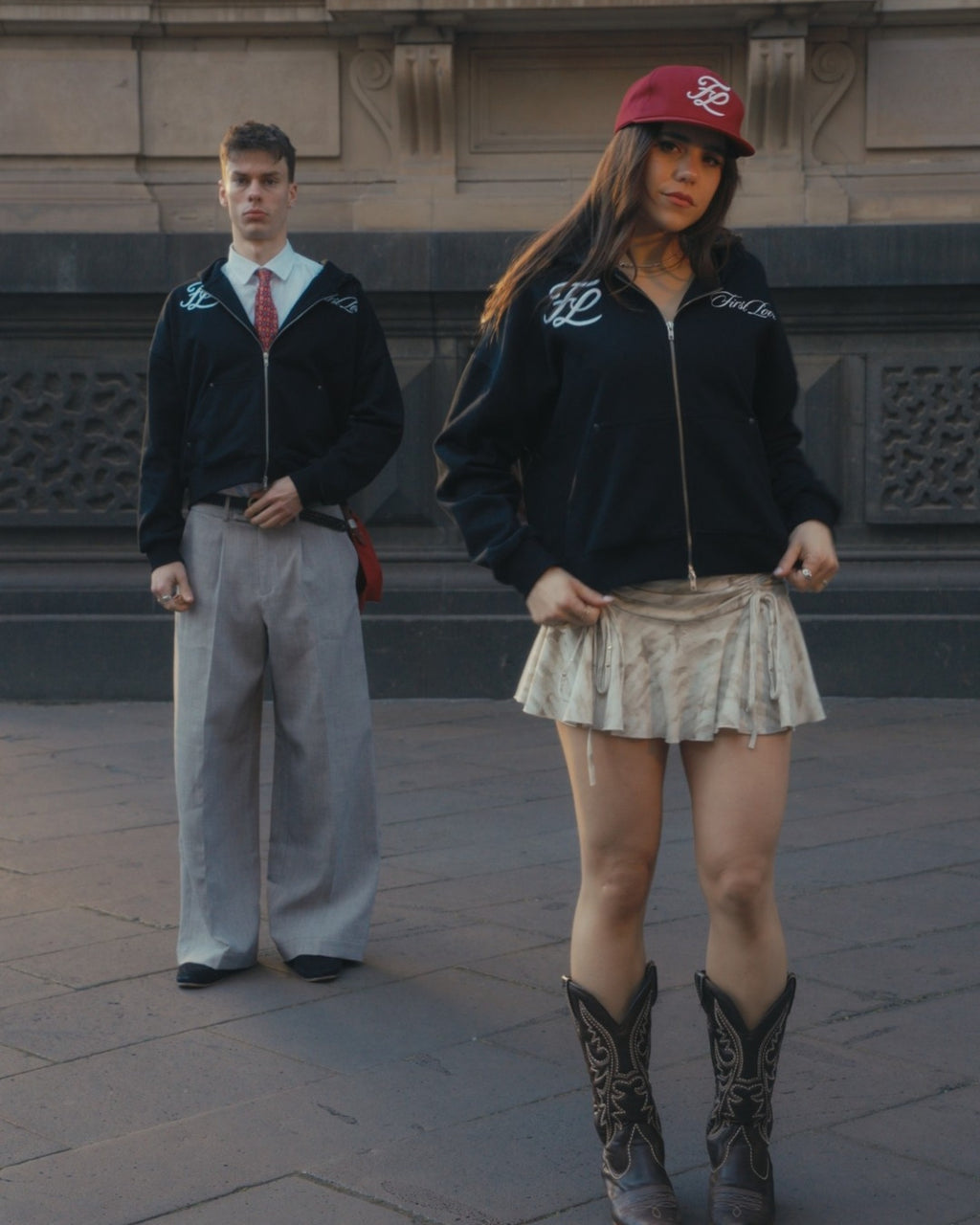 Black hoodie and red cap on body, styled as a pair