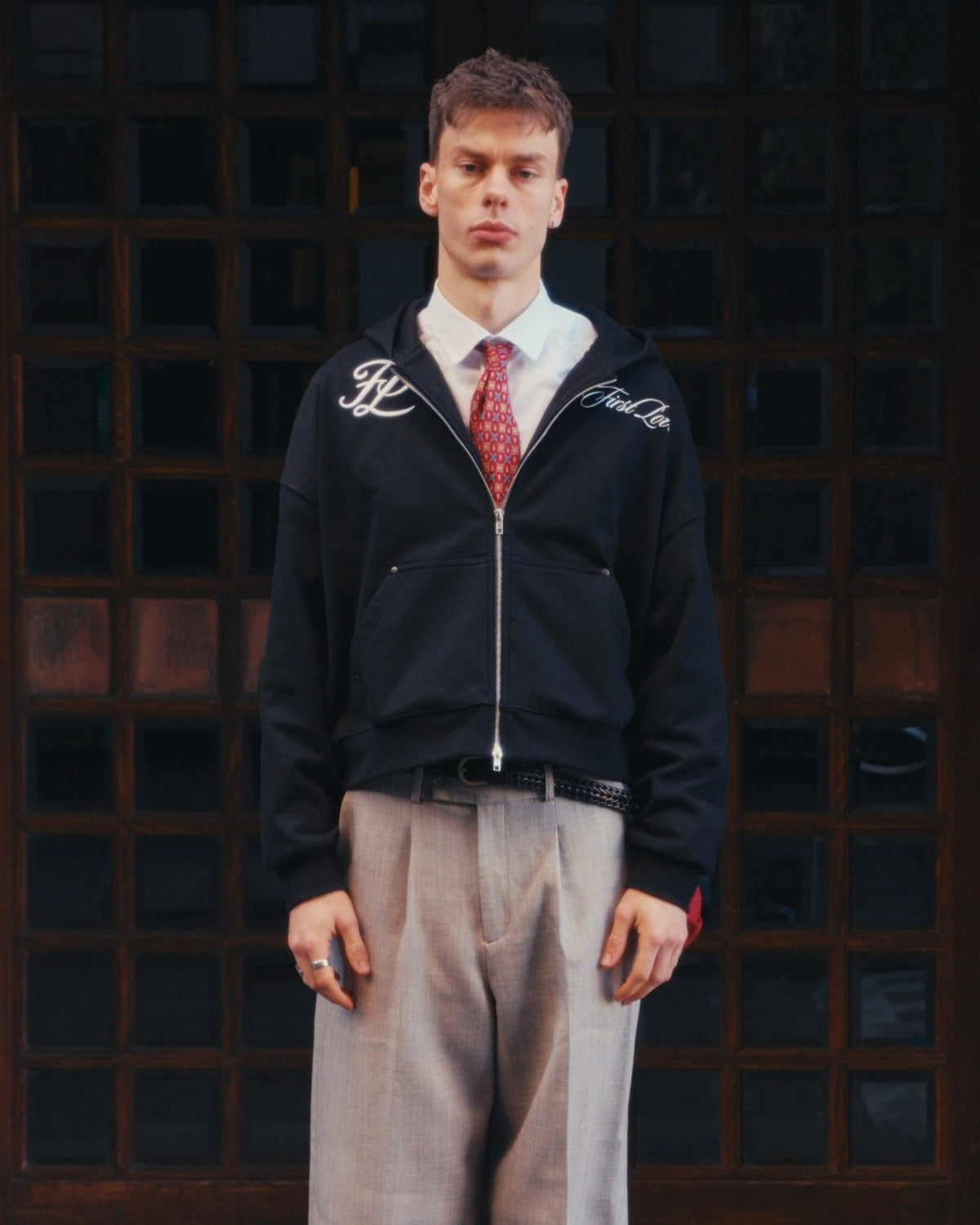 Black hoodie on body, front, styled with shirt and tie